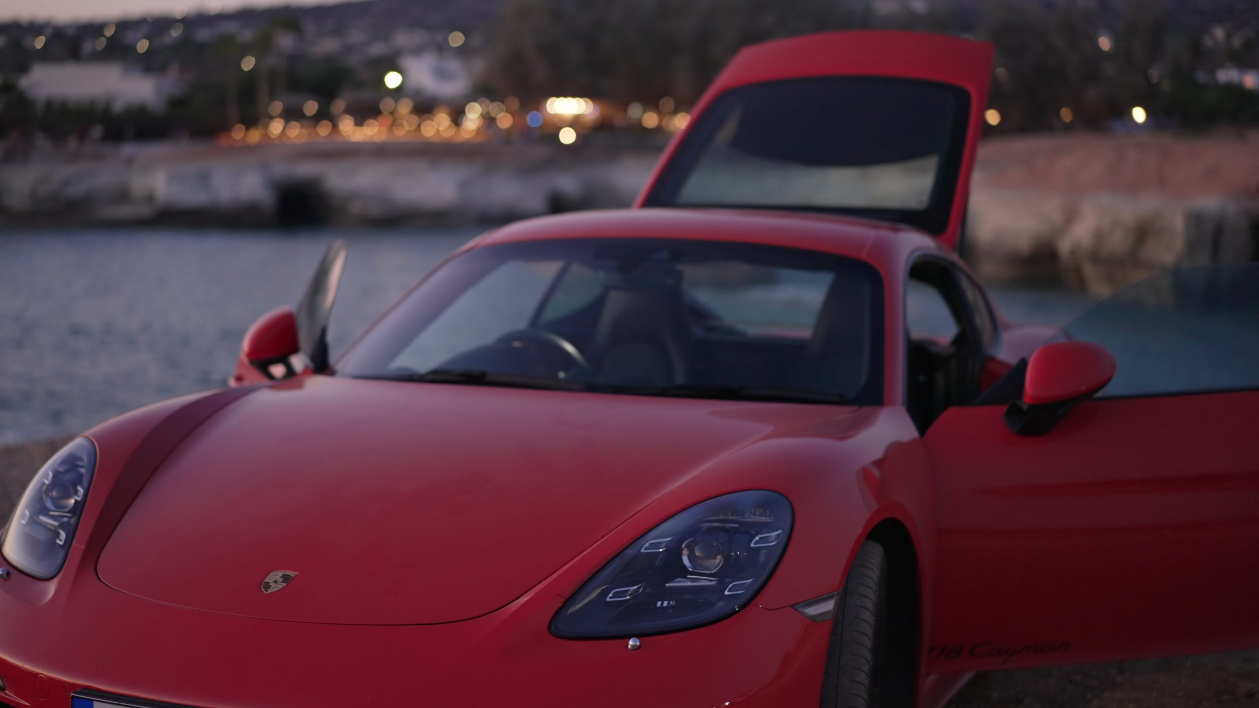 luxurious-modern-red-car-with-open-doors-and-trunk-outdoors-at-dusk-on-mediterranean-s-SBI-349915482 porsche repair, porsche cayenne, porsche 911 gt3 rs, porsche panamera